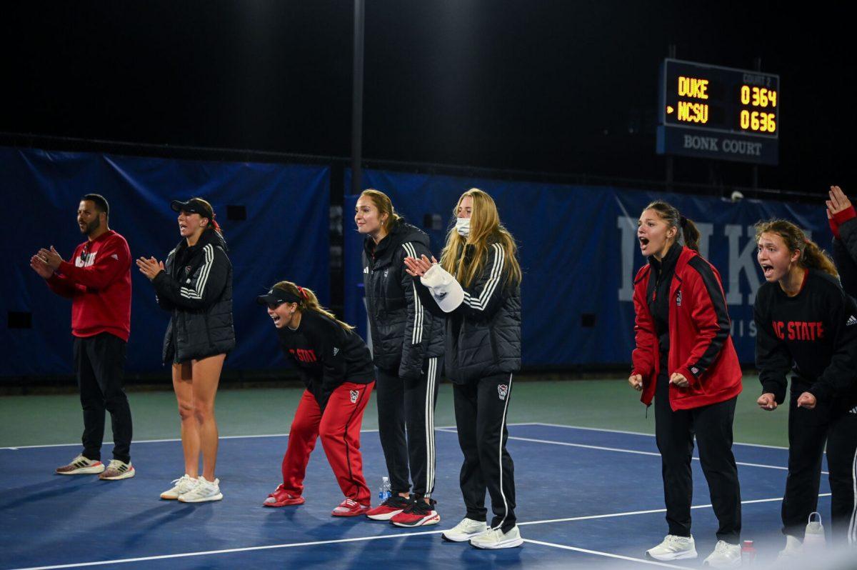 The NC State tennis team cheers for freshman Mia Slama during the match against Duke at Ambler Tennis Stadium on Friday, March 21, 2025. NC State fell to Duke 3-4.