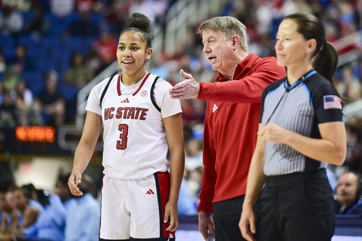 NC State women's basketball head coach Wes Moore talks to freshman guard Zamareya Jones after she fouls during the semifinals game of the ACC Tournament against UNC-Chapel Hill in Greensboro Coliseum on Saturday, March 8, 2025. The team collected 22 personal fouls total. NC State beat UNC 66-55.