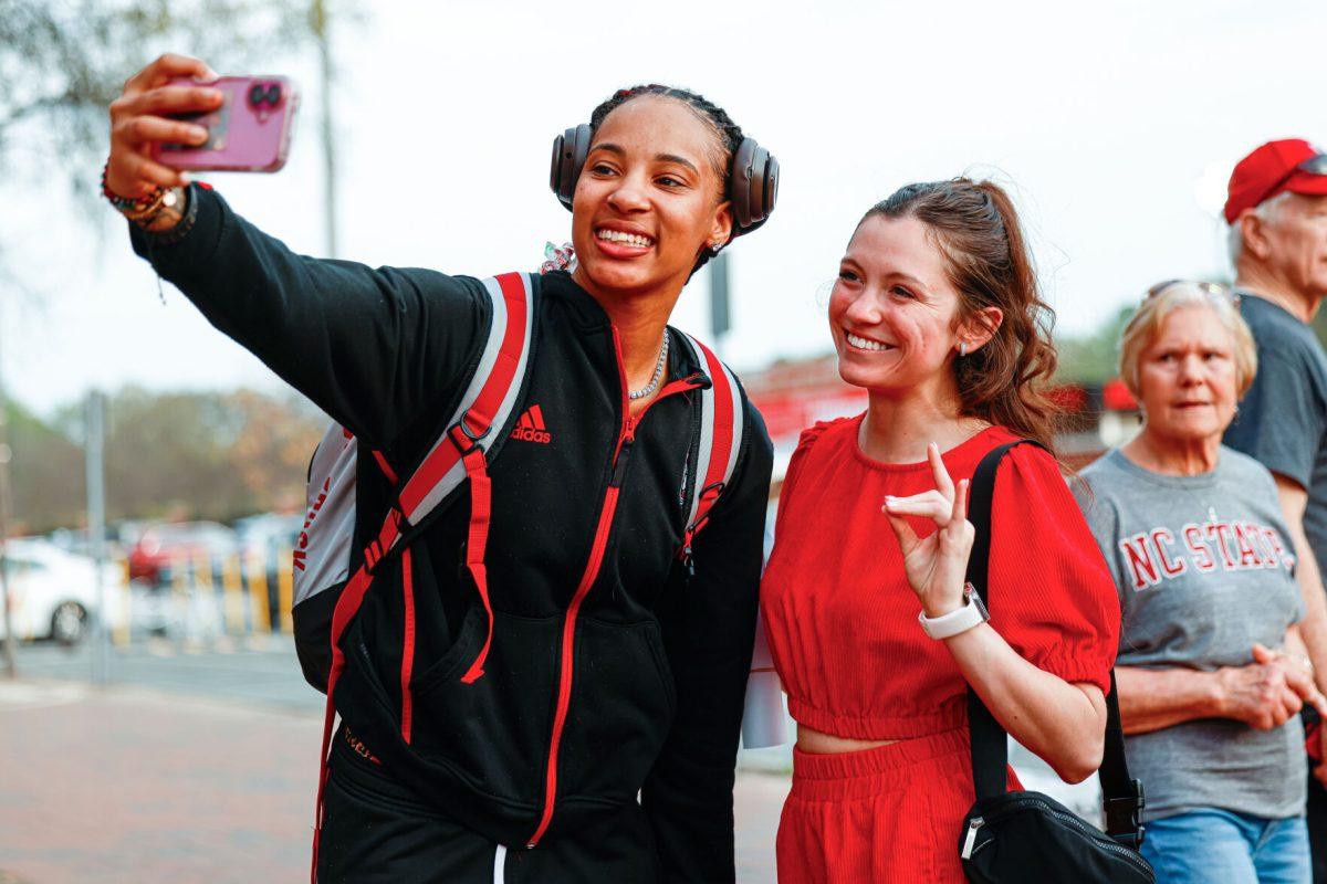 Senior guard Aziaha James takes a selfie with a few fans during the teams welcome back to Reynolds Coliseum on Saturday, March 29. James played in all 35 games during her senior season averaging 17.9 points per game.