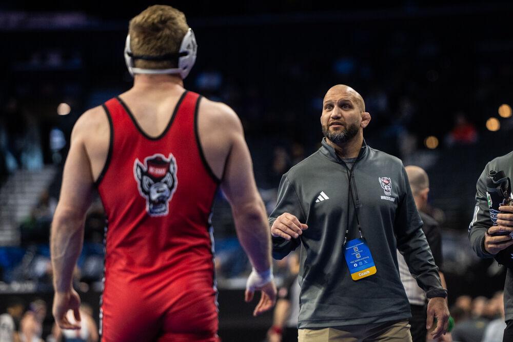 Associate head coach Zack Esposito coaches redshirt sophomore Dylan Fishback during the NCAA Wrestling Championship Tournament in the Wells Fargo Center on Friday, March 21, 2025.&#160;The Wolfpack placed eighth in the tournament with 46.5 points.