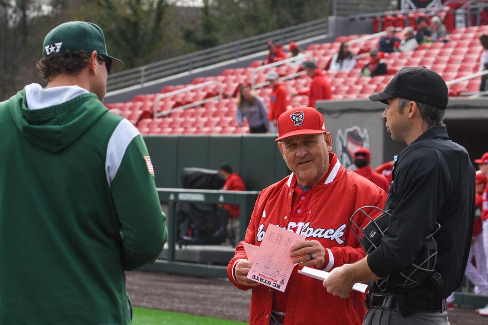 Head coach Elliot Avent speaks to the umpire and Wright State head coach Alex Sogardon during the game against Wright State on Doak Field at Dail Park on Friday, March 7, 2025. The Wolfpack currently has nine wins and five loses this season. NC State won against Wright State 6-4.
