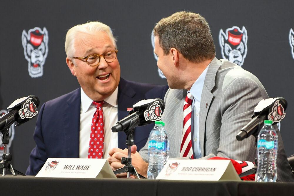 Randy Woodson, chancellor of NC State, laughs alongside Will Wade, the new head coach of NC State men's basketball, during a press conference discussing Wade's hiring inside Reynolds Coliseum on Tuesday, March 25, 2025. Wade will serve as the new men's basketball coach after having been at McNeese State.