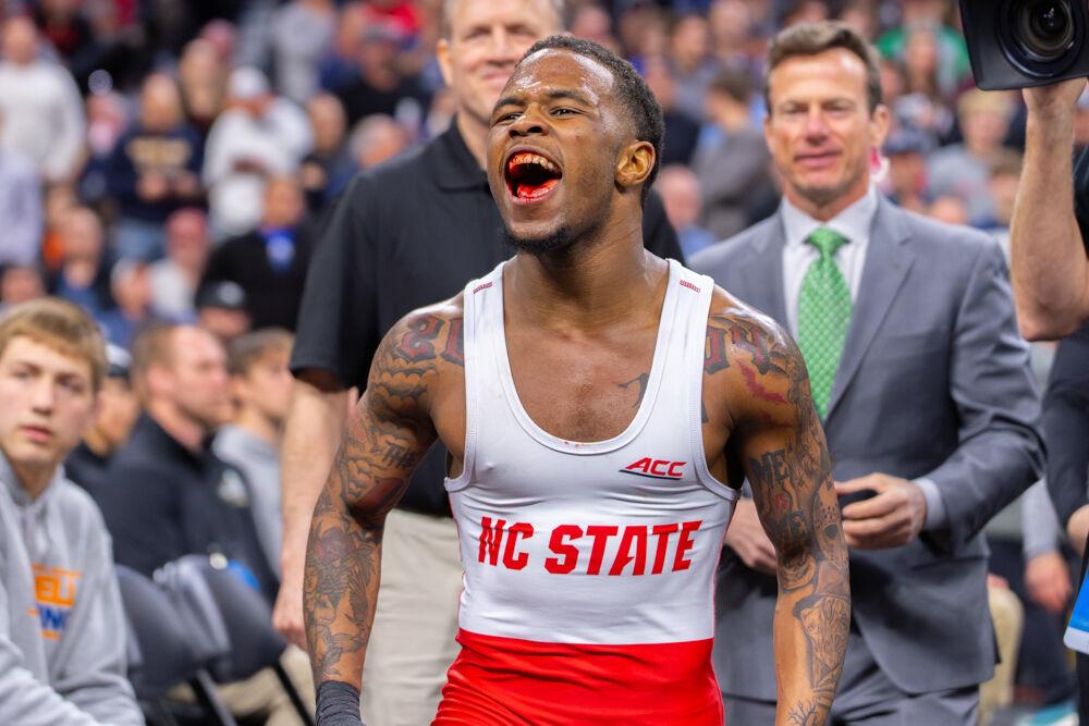 Redshirt freshman Vince Robinson celebrates his championship win during the NCAA Wrestling Championship Tournament in the Wells Fargo Center on Saturday, March 22, 2025.&#160;Robinson won the championship for the 125 pound weight class. The Wolfpack placed eighth overall with 46.5 points.