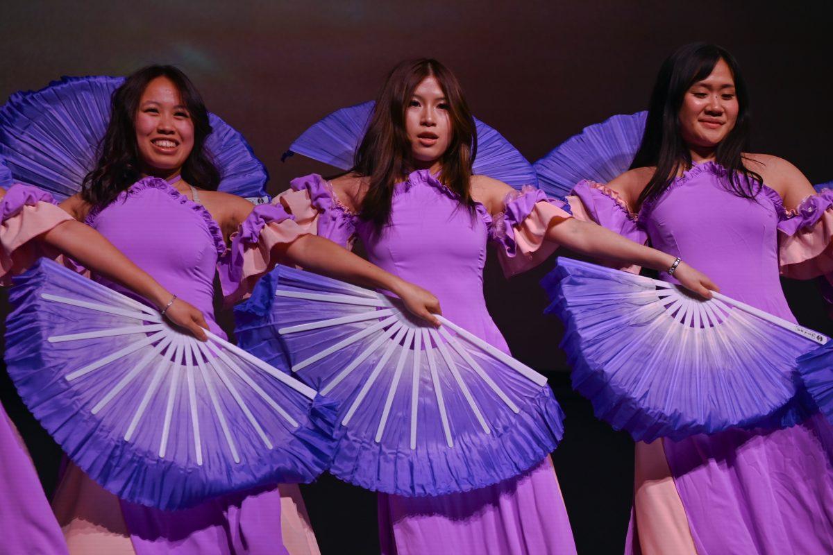 Members of Tu Linh perform with hand fans during the Vietnamese Student Association's annual spring semester culture show, The Art of Passion, at Witherspoon Student Center on March 22, 2025. The show was hosted by NC State's VSA and included an engaging story about a young girl on her journey to find her true passion and featured multiple performances from students of various schools.
