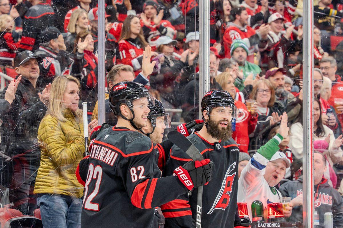 Defender Brent Burns and center Jesperi Kotkaniemi celebrate a Carolina goal during the game against the Boston Bruins at the Lenovo Center on Saturday, March 6, 2025. The Hurricanes beat the Bruins 3-2.