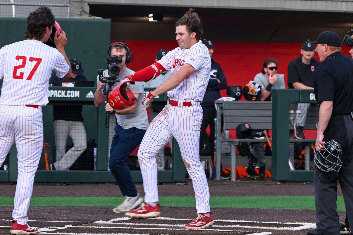 Junior outfielder Josh Hogue flexes after hitting a grand slam during the game against Campbell on Doak Field at Dail Park on Wednesday, March 5, 2025. The Wolfpack defeated the Fighting Camels 11-1. Hogue recorded one hit, a grand slam, which drove in four RBIs, along with one walk and no strikeouts.