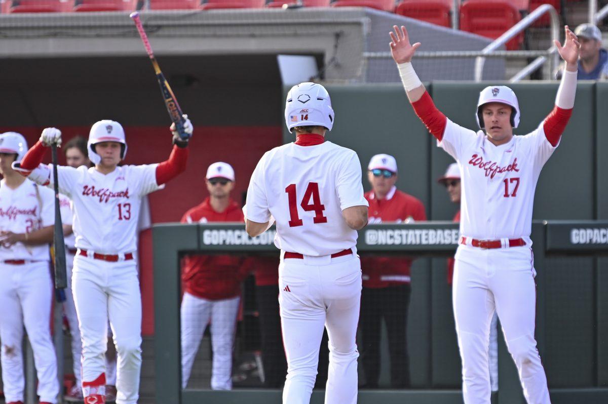 Freshman outfielder Ty Head runs to home base to celebrate with his teammates during the baseball game against Liberty on Doak Field at Dail Park on Tuesday, Feb. 18, 2025. In the three times Head was at bat, he scored one run and made two hits. NC State lost to Liberty 8-9.