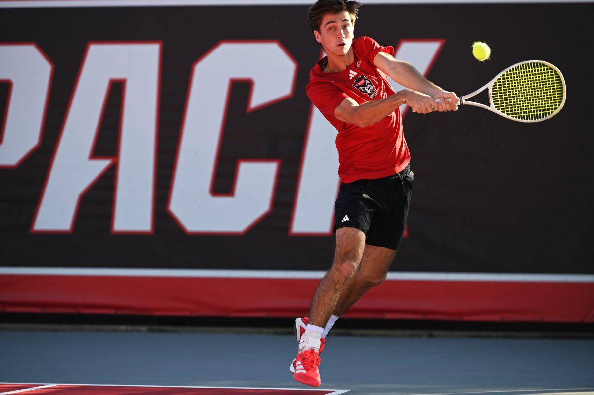 Senior Braden Shick backhands the ball during his singles match versus Cal at J.W. Isenhour tennis center on Friday, Feb. 28, 2025. Shick's singles match was unfinished. The Wolfpack beat the Golden Bears 4-2.