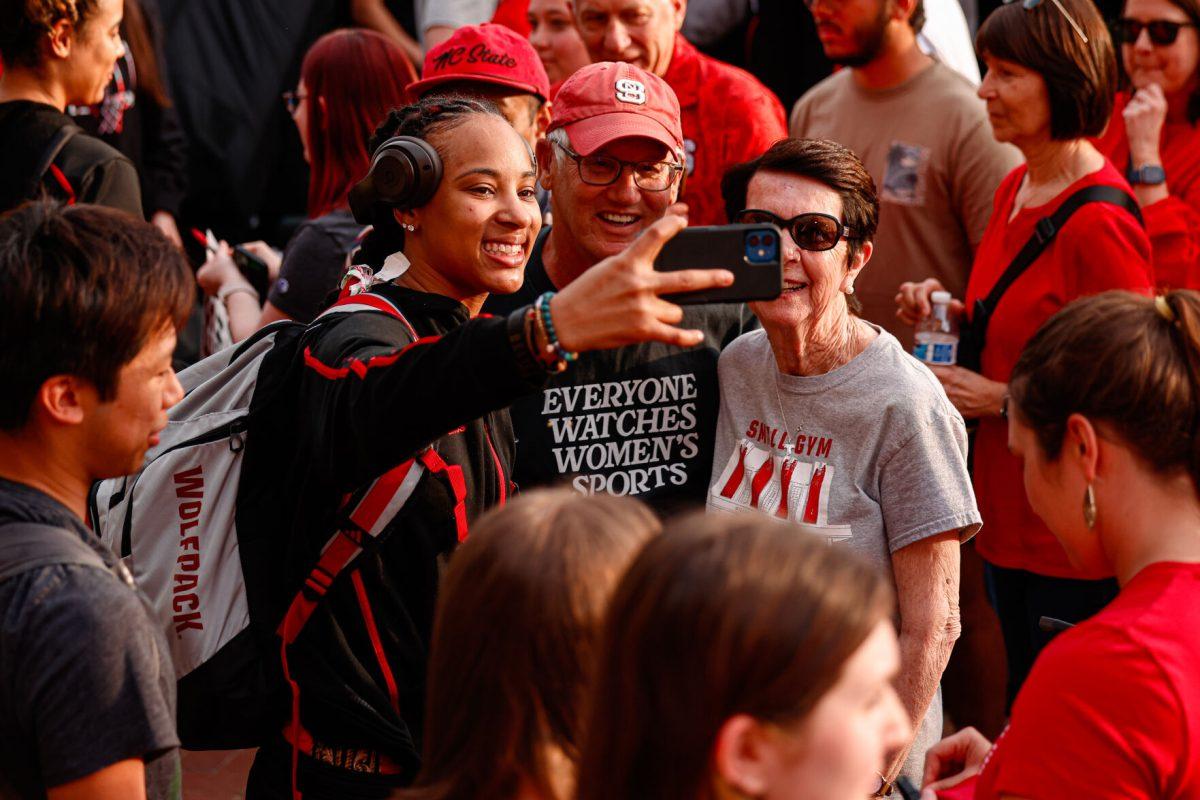 Senior guard Aziaha James takes a selfie with a few fans during the teams welcome back to Reynolds Coliseum on Saturday, March 29. James played in all 35 games during her senior season averaging 17.9 points per game.