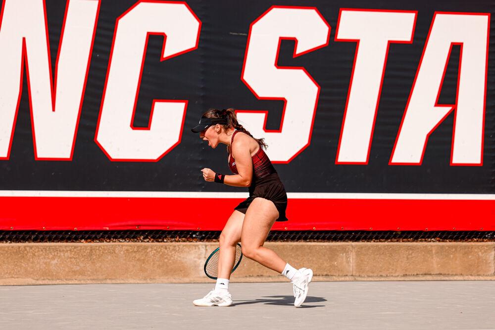 Freshman Michaela Laki screams in celebration after scoring a point during her singles game against Clemson at J.W. Isenhour Tennis Center on Friday, March 28, 2025. Laki won her singles match 6-4, 4-3. NC State won the match 4-0.