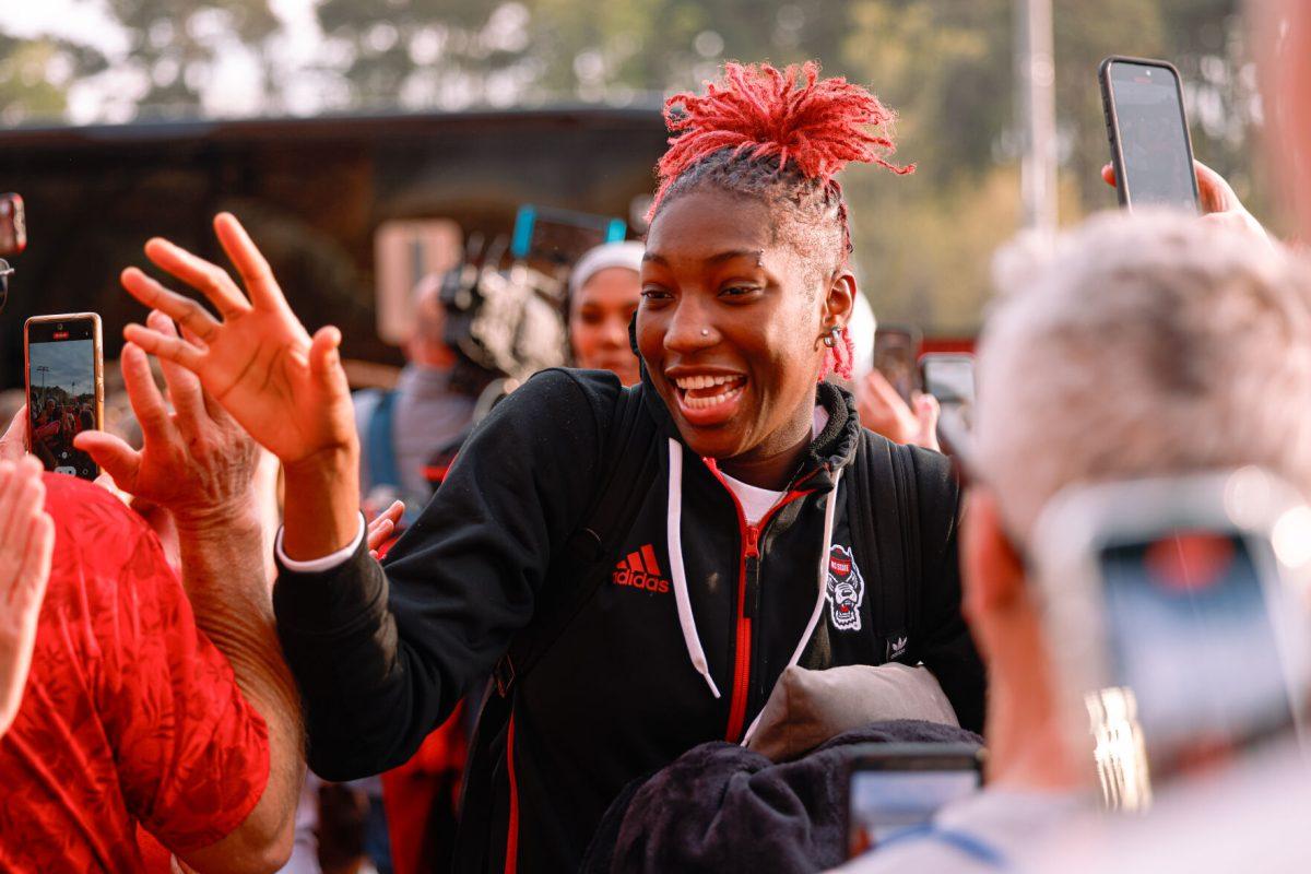 Senior guard Saniya Rivers high-fives the fans during their welcome back to Reynolds Coliseum on Saturday, March 29. Rivers played in all 35 games during her senior season averaging 1.3 blocks per game.