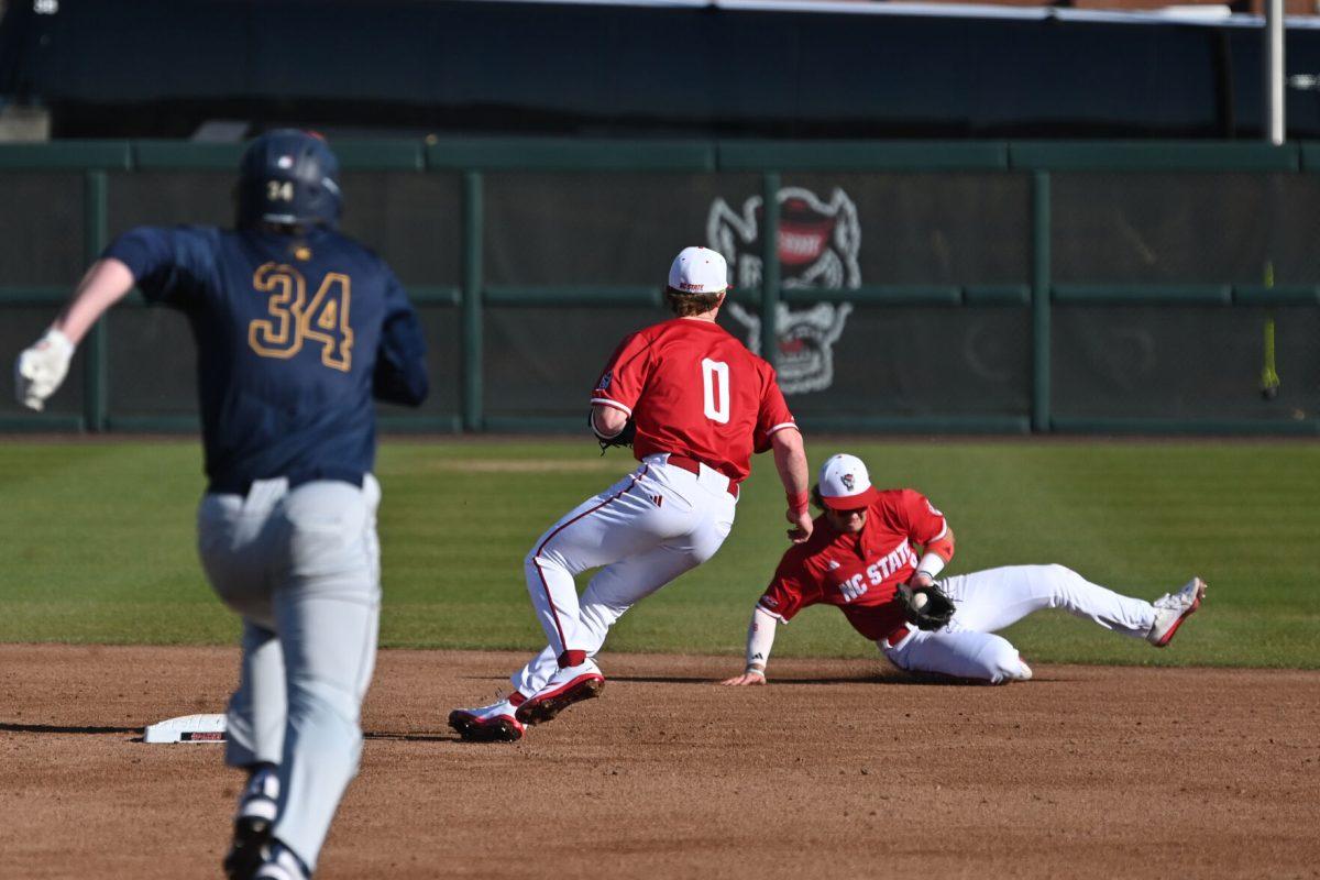 Senior infielder Justin DeCriscio lays out and makes the play to sophomore infielder Luke Nixon for the out during NC State's game against the Canisius Golden Griffins on Doak Field at Dail Park on Friday, Feb. 28, 2025. The Wolfpack beat the Golden Griffins 10-2 to take the first game of the series.