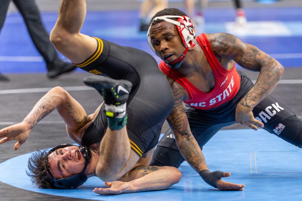 Redshirt freshman Vince Robinson advances his position during the NCAA Wrestling Championship Tournament in the Wells Fargo Center on Thursday, March 20, 2025.&#160;Robinson won the championship for the 125 pound weight class. NC State placed eighth in the tournament with 46.5 points.