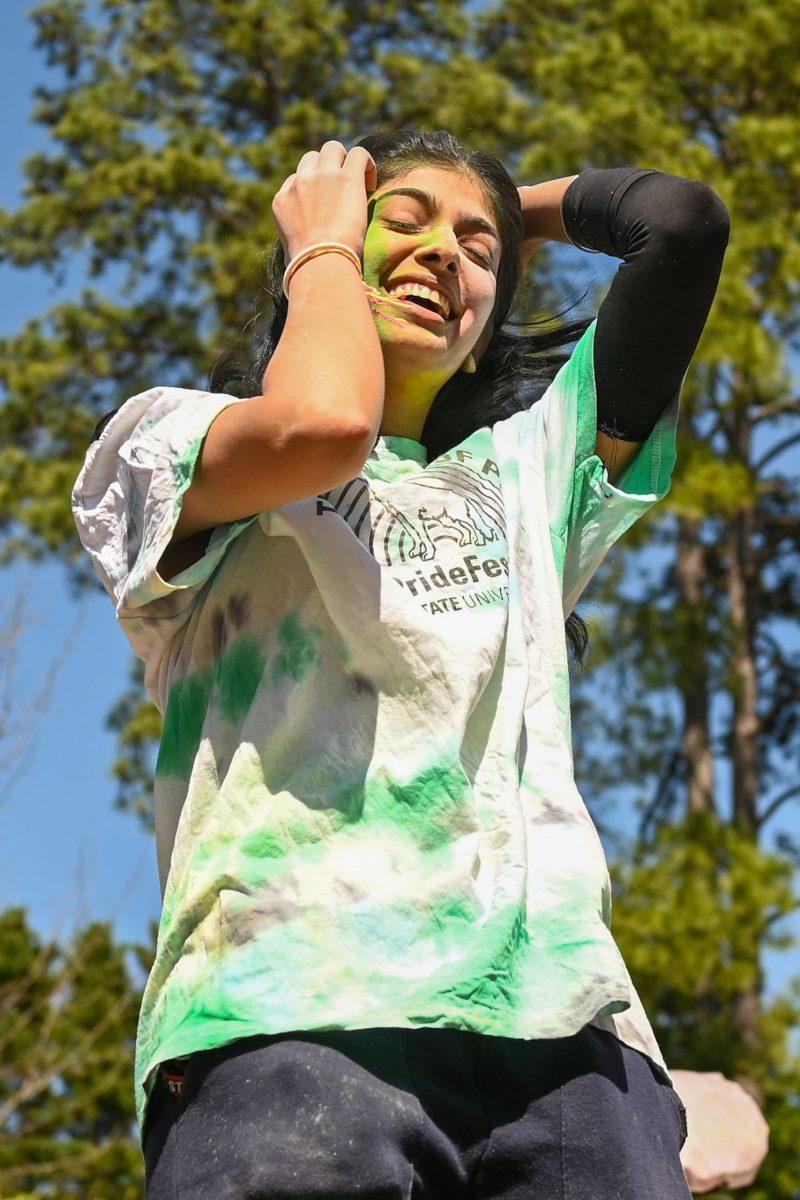 Nandni Patel, a third-year studying human biology, dances with friends during Holi at Stafford Commons on Saturday, March 22, 2025. Holi is known as the Festival of Colors, and celebrates spring by throwing colored powder.