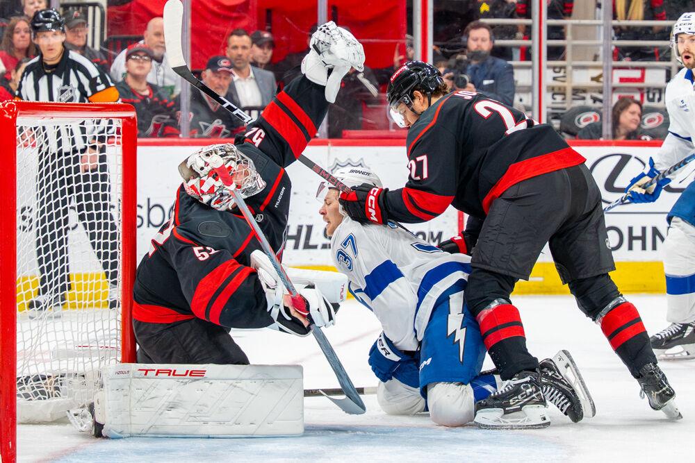 Center Tyson Jost shoves an opponent during the game against the Tampa Bay Lightning at the Lenovo Center on Tuesday, March 11, 2025. Jost had zero shot&#8217;s on goal. The Hurricanes beat the Lightning 4-1.
