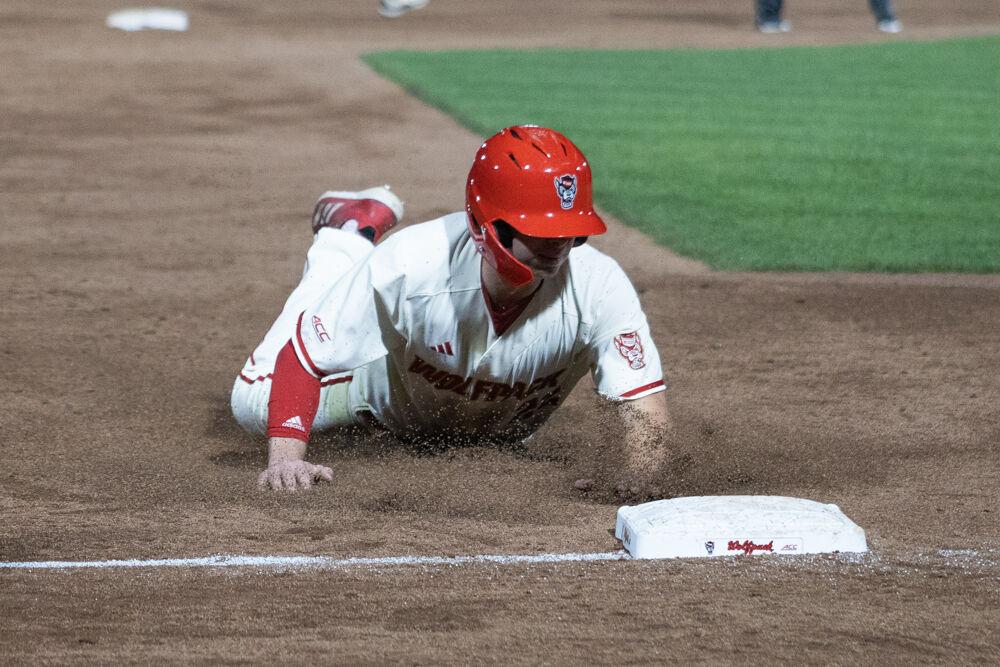 Junior outfielder Josh Hogue slides into third base during the game against USC-Upstate on Doak Field at Dail Park on Tuesday, March 25, 2025. The game ended in the eighth inning due to the mercy rule.&#160;The Wolfpack lost to the Spartans 15-5.