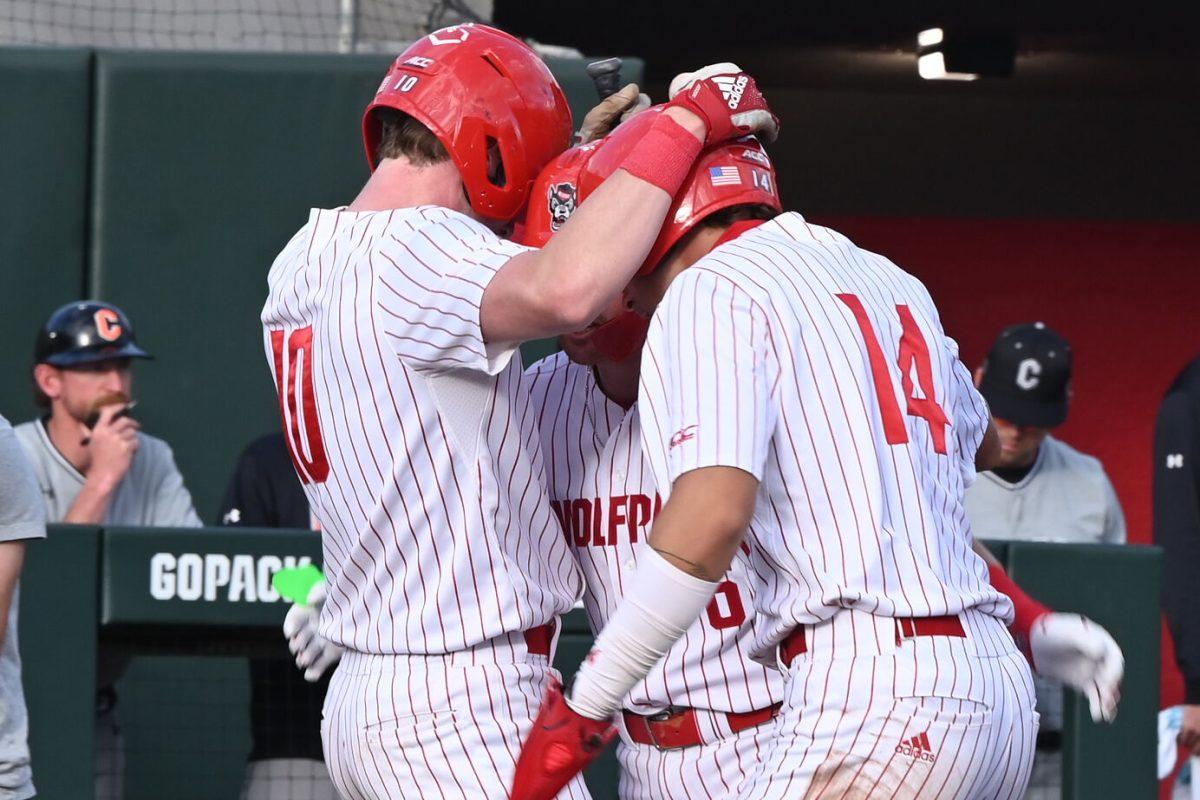Sophomore infielder Ryan Jaros, junior infielder Matt Heavner, and freshman outfielder Ty Head embrace after the homerun during the game against Campbell on Doak Field at Dail Park on Wednesday, March 5, 2025. The Wolfpack defeated the Fighting Camels 11-1. Heavner recorded two hits including a home run for three RBIs.
