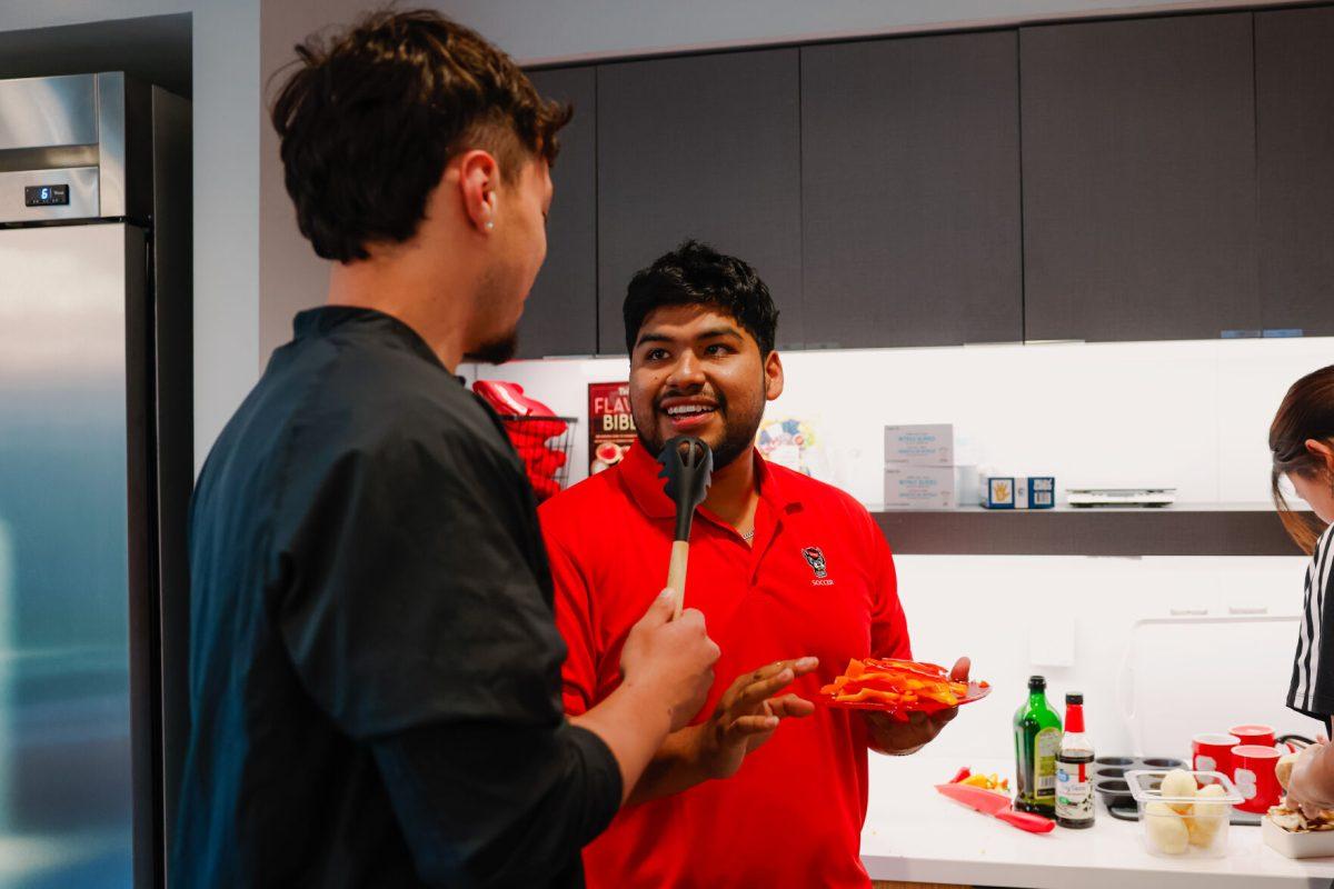 Brian Reyes, third-year studying electrical engineering, interviews Angel Ayala, fourth-year studying construction engineering during the MGC Chopped: Cooking Competition at Carmichael gym on Wednesday, March 26, 2025. Reyes was on team one which ended up having the better taste score 23-21 but lost the overall point score 67-66.