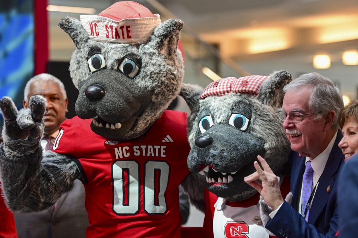 Mr. and Mrs. Wuf poses with North Carolina Representative Donny Lambeth during the new chancellor announcement in Talley Student Union on Tuesday, March 18, 2025. Kevin Howell will be the 15th chancellor of NC State and the first Black chancellor.