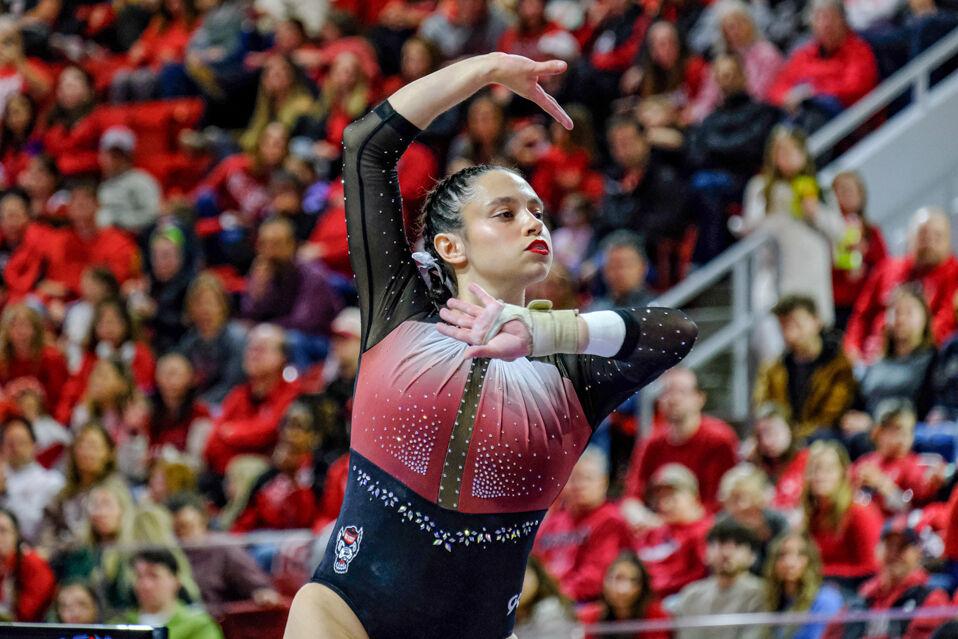 Graduate Chloe Negrete poses on the balance beams during the meet against UNC-Chapel Hill&#160;at Reynolds Coliseum on Friday, Feb. 21, 2025. Negrete scored a 9.975 on the floor exercise. NC State beat UNC 197.025-195.500.