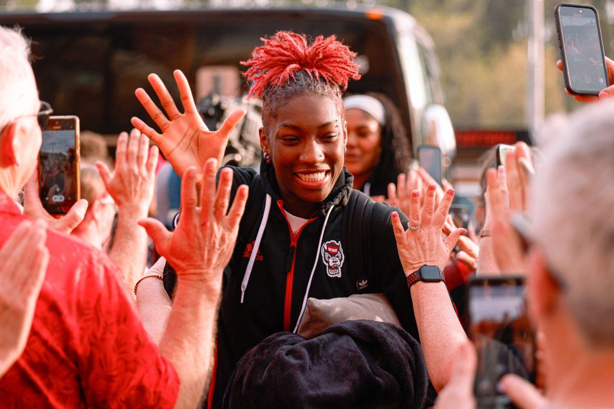 Senior guard Saniya Rivers high-fives the fans during their welcome back to Reynolds Coliseum on Saturday, March 29. Rivers played in all 35 games during her senior season averaging 11.9 points per game.