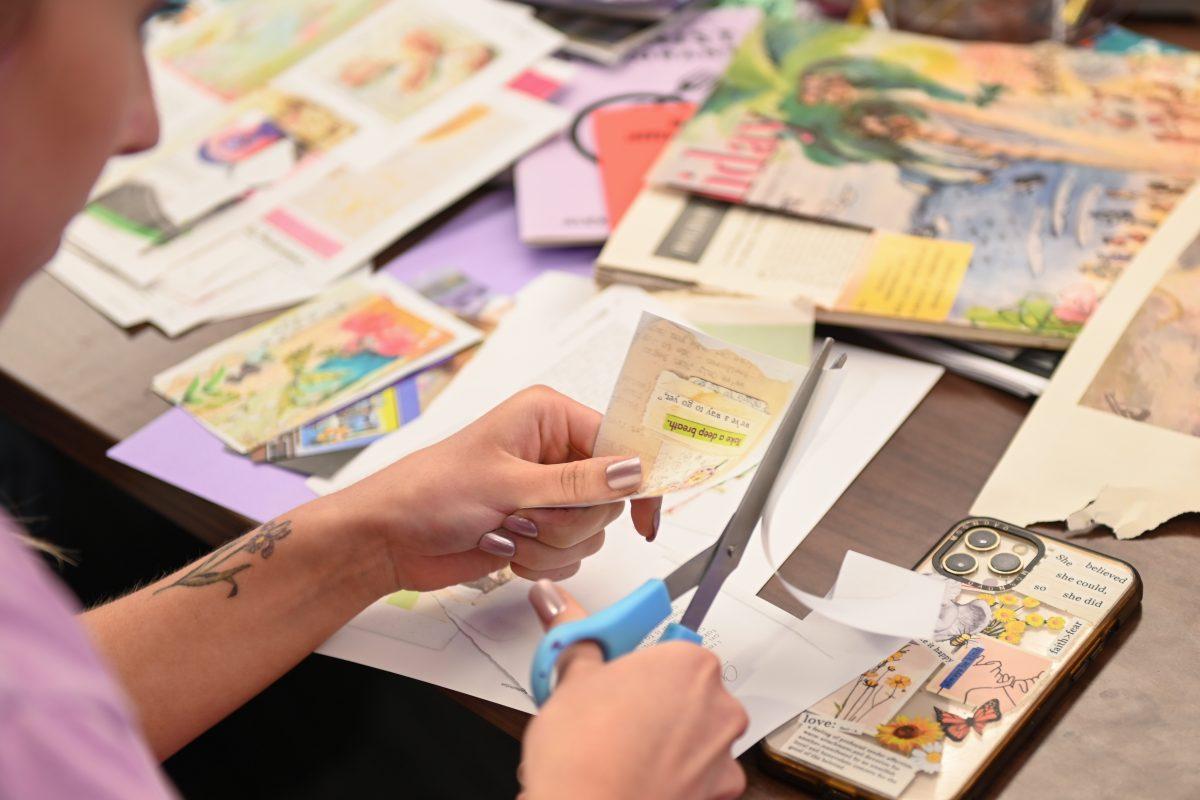 Shayla Bergeron, a second-year studying psychology, creates a zine in the Women's Center on Tuesday, March 25, 2025. The Women's Center's mission is to foster "a sense of community and belonging through intentional programming and services focused on supporting student success and retention."
