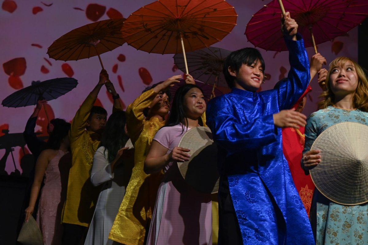 VSA Traditional perform with umbrellas during the Vietnamese Student Association's annual spring semester culture show, The Art of Passion, at Witherspoon Student Center on March 22, 2025. The show was hosted by NC State's VSA, who worked with students from other schools to put on colorful performances in addition to the show's engaging storyline.