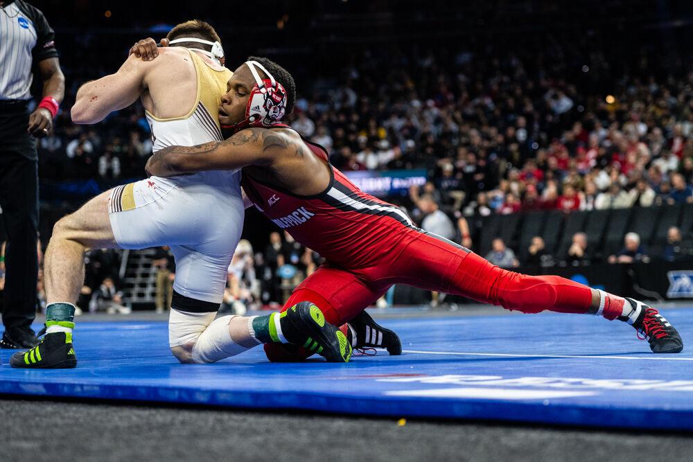 Redshirt freshman Vince Robinson remains within bounds during the semifinal round of the NCAA Wrestling Championship Tournament in the Wells Fargo Center on Friday, March 21, 2025.&#160;Robinson won the championship for the 125 pound weight class. The Wolfpack placed eighth overall with 46.5 points.