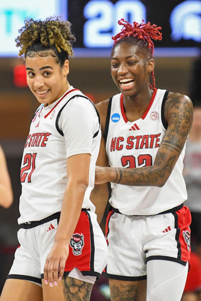 Senior guard Saniya Rivers (right) laughs alongside graduate guard Madison Hayes (left) after Hayes scored during the second round game of the NCAA Tournament against Michigan State in Reynolds Coliseum on Monday, March 24, 2025. NC State won the game 83-49.