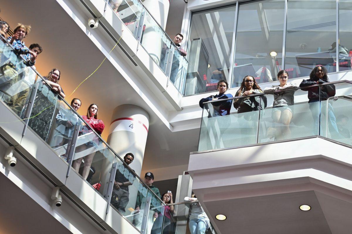 Students watch the new chancellor announcement from the third and fourth floor of Talley Student Union on Tuesday, March 18, 2025. Kevin Howell is the third chancellor to be an NC State graduate after graduating in 1988 with a bachelor's degree in political science and serving as the first Black student body president.