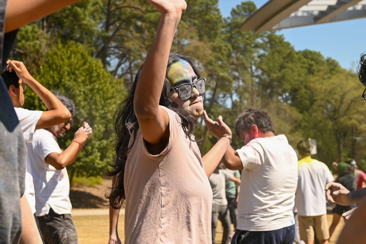 Krisha Patel, a first-year studying computer science, dances while colored during Holi at Stafford Commons on Saturday, March 22, 2025. Holi is known as the Festival of Colors, and celebrates spring by throwing colored powder.