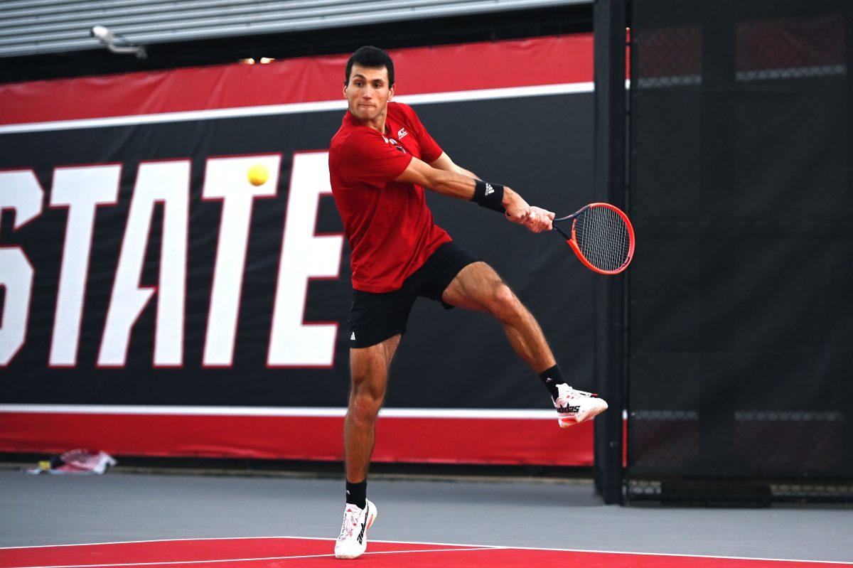 Senior Luca Staeheli jumps to return the ball during his singles match versus Cal at J.W. Isenhour tennis center on Friday, Feb. 28, 2025. Staeheli won his singles match 2-0 (6-1, 6-3). The Wolfpack beat the Golden Bears 4-2.