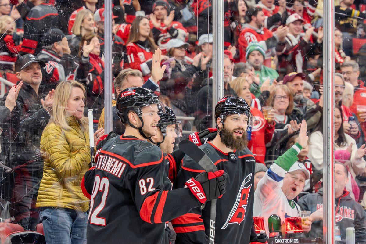 Defender Brent Burns and center Jesperi Kotkaniemi celebrate a Carolina goal during the game against the Boston Bruins at the Lenovo Center on Saturday, March 6, 2025. The Hurricanes beat the Bruins 3-2.
