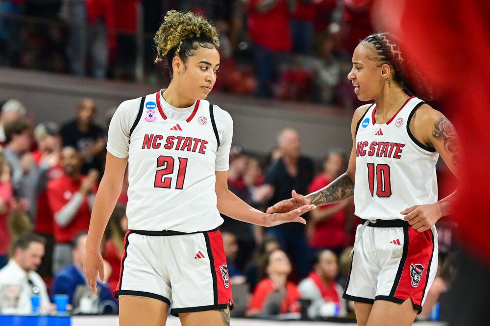 Senior guard Aziaha James (right) high-fives graduate guard Madison Hayes (left) during the second round game of the NCAA Tournament against Michigan State in Reynolds Coliseum on Monday, March 24, 2025. The Wolfpack beat the Spartans 83-49.