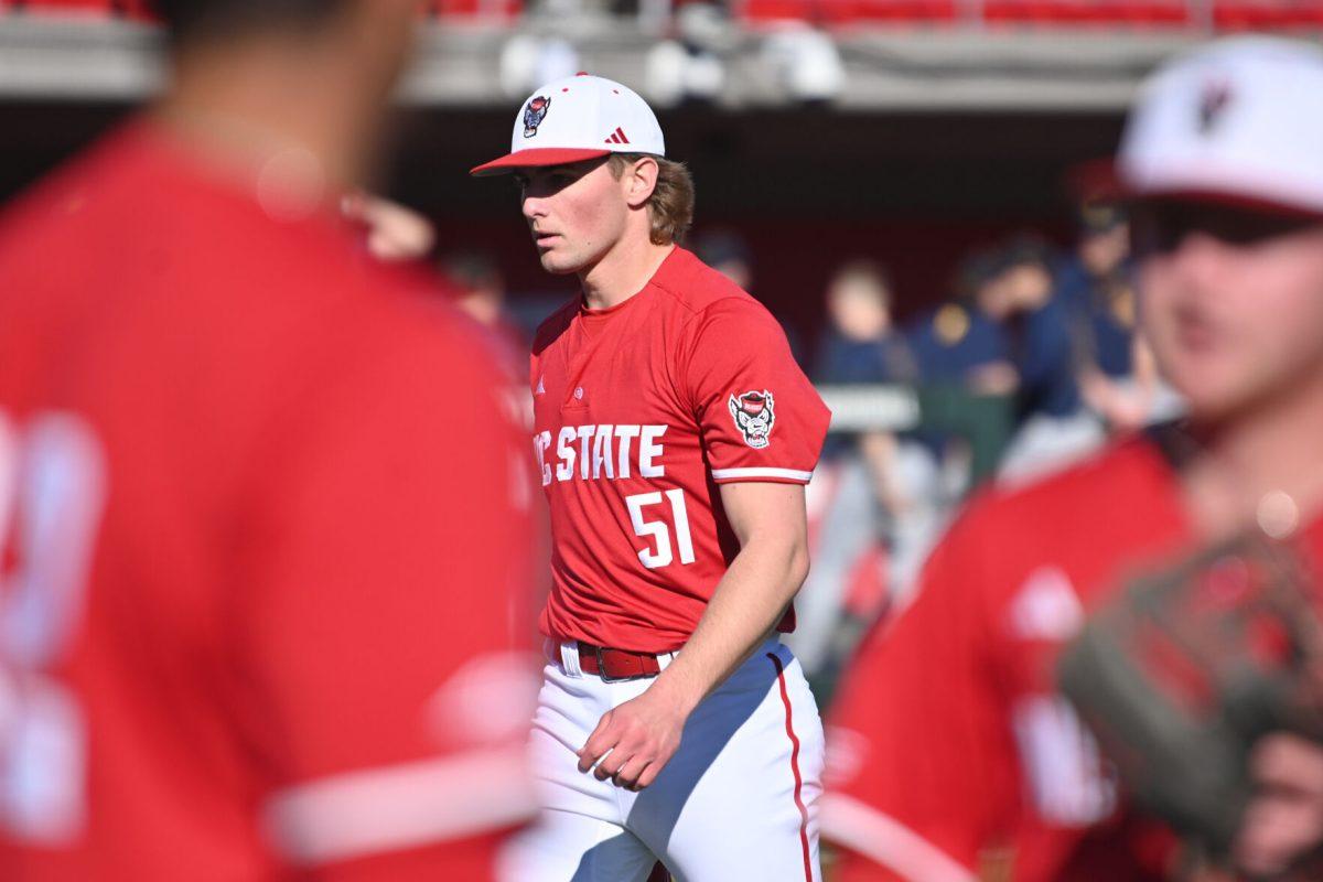 Junior pitcher Dominic Fritton walks back to the dugout after ending an inning during NC State's game against the Canisius Golden Griffins on Doak Field at Dail Park on Friday, Feb. 28, 2025. Fritton recorded 12 strike outs and gave up two runs, with only one earned, off of six hits on six innings pitched. The Wolfpack beat the Golden Griffins 10-2 to take the first game of the series.