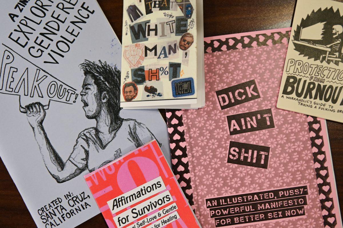 Zines from the Women's Center's zine library are posed during A Womanist History of Scrapbooks and Zines event in the Women's Center on Tuesday, March 25, 2025. The Women's Center's hosted the event to examine the role of scrapbooks and zines in feminist and womanist movements.