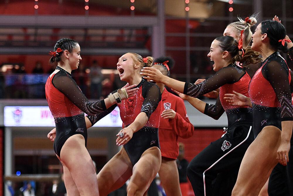 Graduate student Chloe Negrete is congratulated by the team after her floor routine during the meet against Ohio State in Reynolds Coliseum on Friday, March 7, 2025. Negrete scored 9.975 in the floor exercise. NC State beat Ohio State 197.000-196.325.