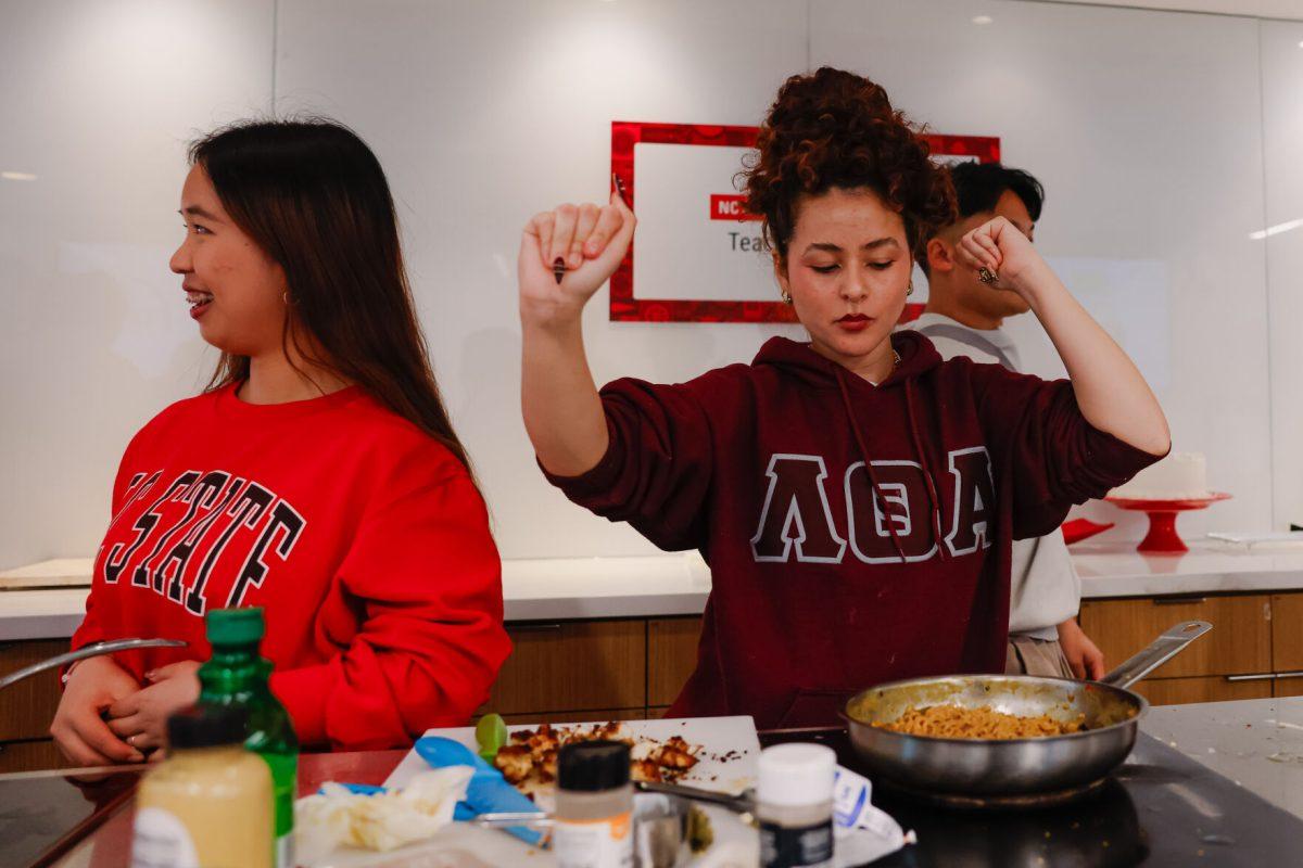 Valeria Gonzalez Perez, fourth-year studying zoology dances while her noodles cook during the MGC Chopped: Cooking Competition at Carmichael gym on Wednesday, March 26, 2025. Perez was on team two which ended up taking the win by one point 67-66.