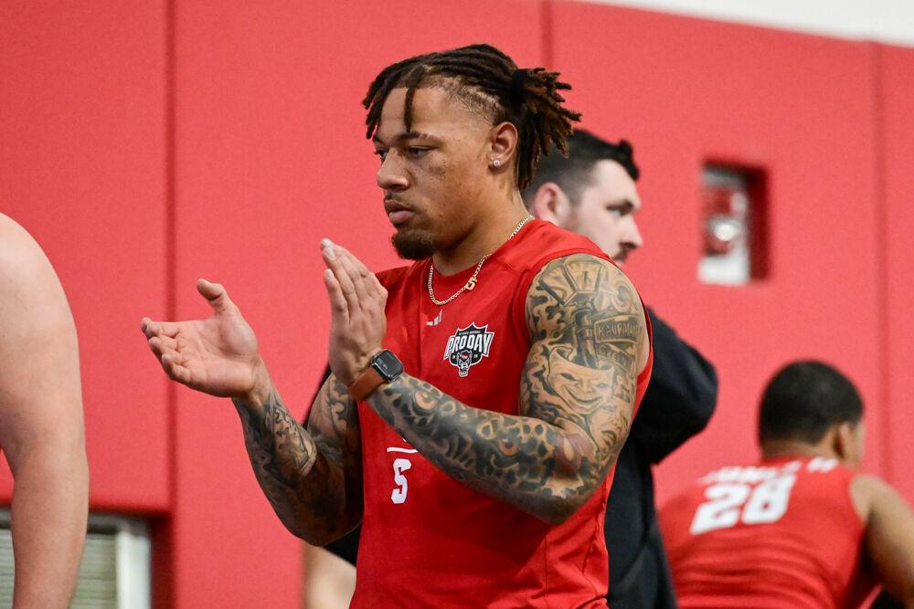 Senior safety DK Kaufman claps for his teammate graduate offensive tackle Anthony Belton during NC State football's Pro Day in the Close-King Indoor Practice Facility on Tuesday, March 25, 2025. NC State players performed a variety of tasks in front of NFL scouts before the upcoming draft.