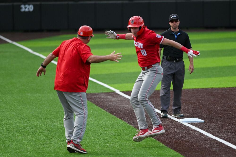 Sophomore infielder Ryan Jaros celebrates with the third base coach during the game against Duke at Jack Coombs Field on Saturday, March 29, 2025. Jaros went two for four with one home run. NC State beat Duke 14-6.