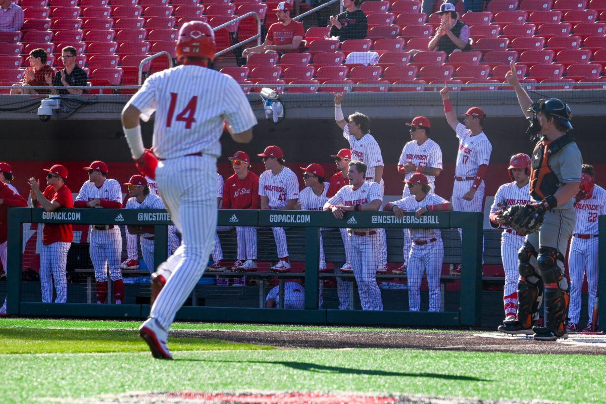 Freshman outfielder Ty Head crosses home plate as the dugout celebrates during the game against Campbell on Doak Field at Dail Park on Wednesday, March 5, 2025. The Wolfpack defeated the Fighting Camels 11-1.