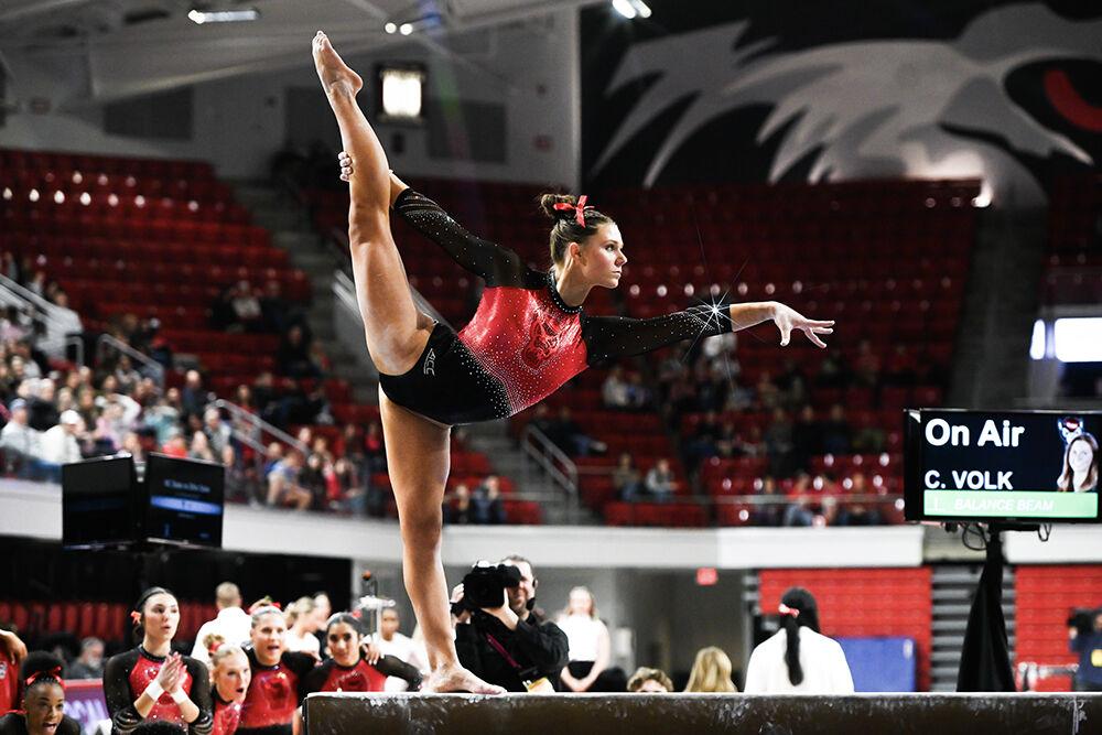 Freshman Caroline Volk poses on the beam during the meet against Ohio State in Reynolds Coliseum on Friday, March 7, 2025. Volk scored 9.900 on the balance beam. The Wolfpack defeated the Buckeyes 197.000-196.325.