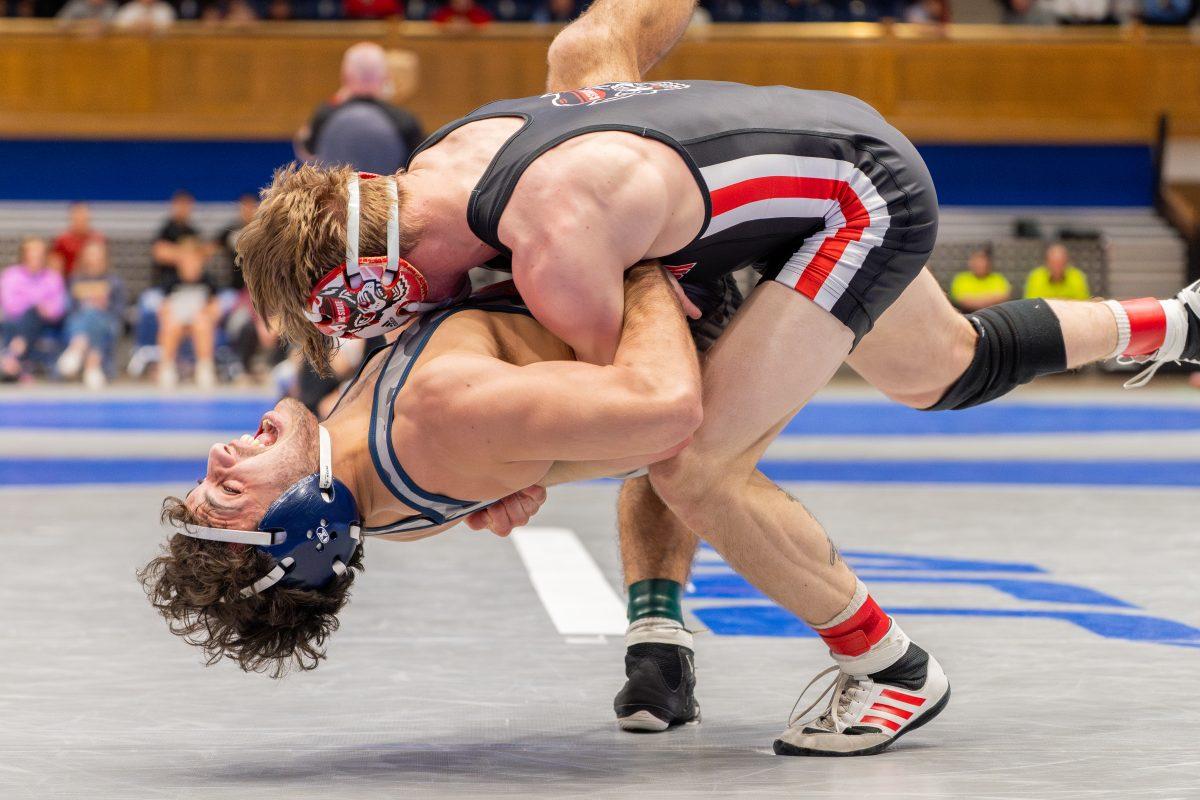 Senior Ed Scott slams down his opponent during the ACC Wrestling Championship Tournament in Cameron Indoor Stadium on Sunday, March 9, 2025. Scott placed second in the 157 weight class. The Wolfpack placed third in the tournament with 62.5 points.