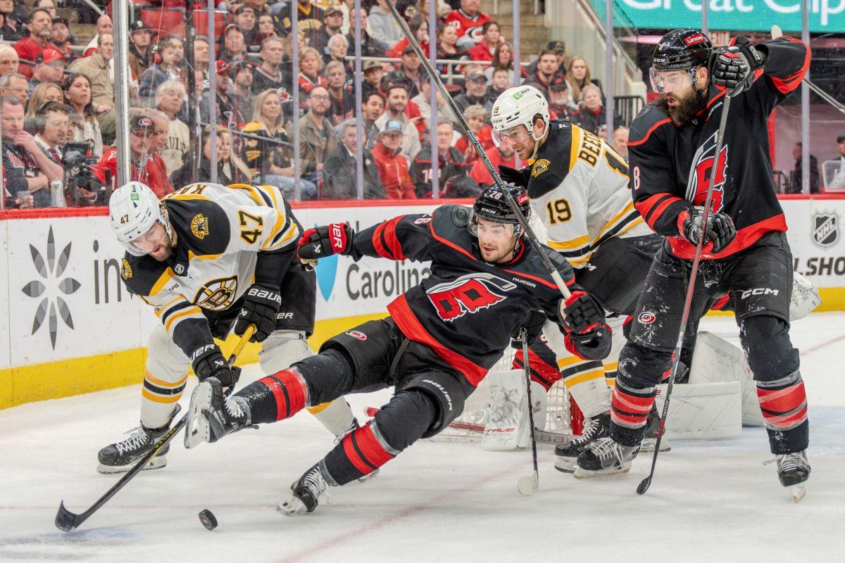 Defender Sean Walker slips while challenging an attacker during the game against the Boston Bruins at the Lenovo Center on Saturday, March 6, 2025. Walker had four hits. The Hurricanes beat the Bruins 3-2.
