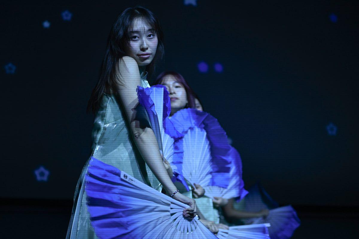 Blue Star perform with hand fans as a blue light is casted on them during the Vietnamese Student Association's annual spring semester culture show, The Art of Passion, at Witherspoon Student Center on March 22, 2025. The show was hosted by NC State's VSA, who worked with guest performers from other schools to put on an engaging show.