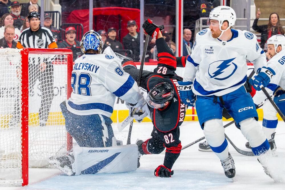Center Jesperi Kotkaniemi falls onto the ice during the game against the Tampa Bay Lightning at the Lenovo Center on Tuesday, March 11, 2025. Kotkaniemi had one shot on goal. The Hurricanes beat the Lightning 4-1.
