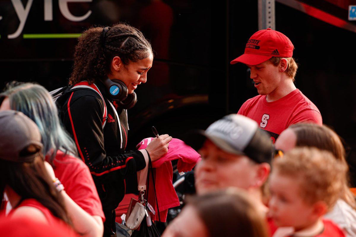 Freshman guard Devyn Quigley signs a fans Play4Kay shirt during the teams welcome back to Reynolds Coliseum on Saturday, March 29. Quigley played in 275 minutes during her freshman season.
