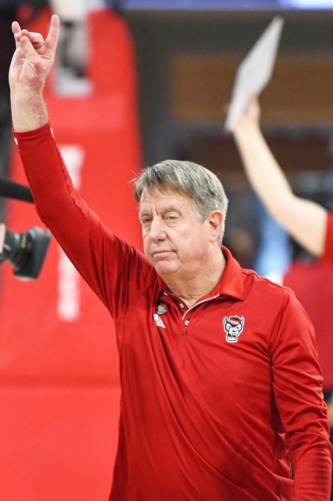 Head coach Wes Moore holds up a "wolfie" at the conclusion of the second round game of the NCAA Tournament against Michigan State in Reynolds Coliseum on Monday, March 24, 2025. NC State won the game 83-49.