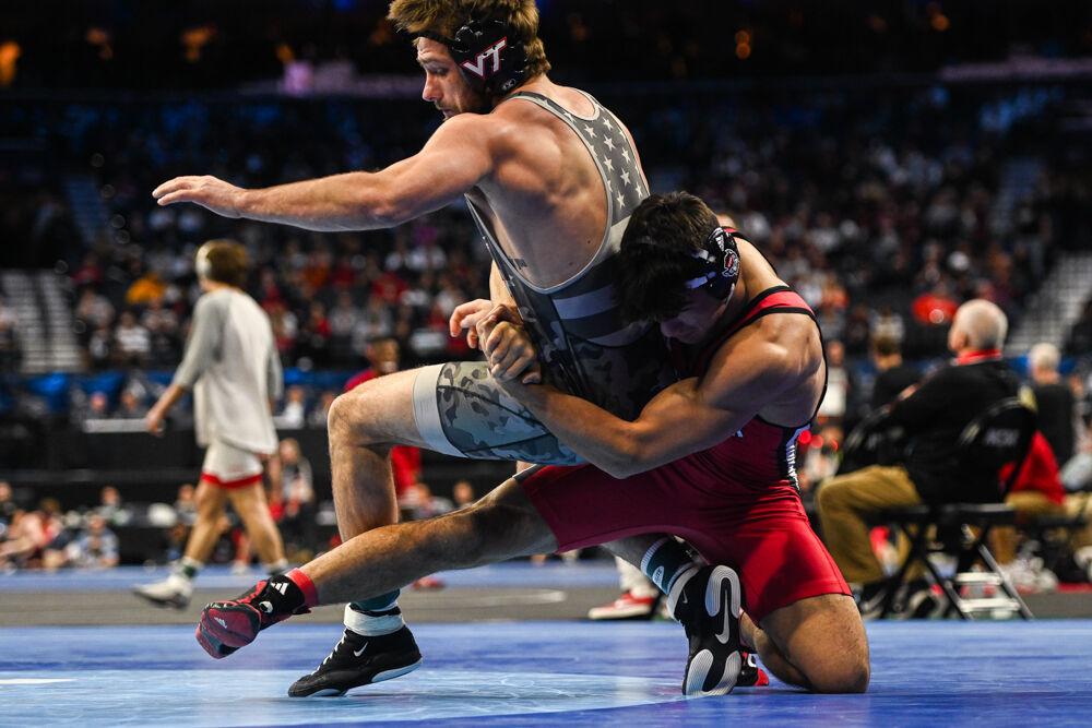 Redshirt sophomore Matty Singleton grasps his opponent for a mat return during the NCAA Wrestling Championship Tournament in the Wells Fargo Center on Friday, March 21, 2025. Singleton placed seventh for the 174 pound weight class. NC State finished eighth in the tournament with 46.5 points.
