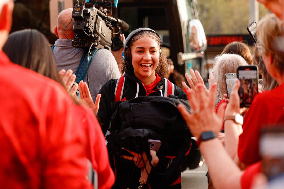 Freshman guard Devyn Quigley puts out her hands to high-five fans during their welcome back to Reynolds Coliseum on Saturday, March 29. Quigley played in 33 games during her freshman season averaging 2.5 points per game.